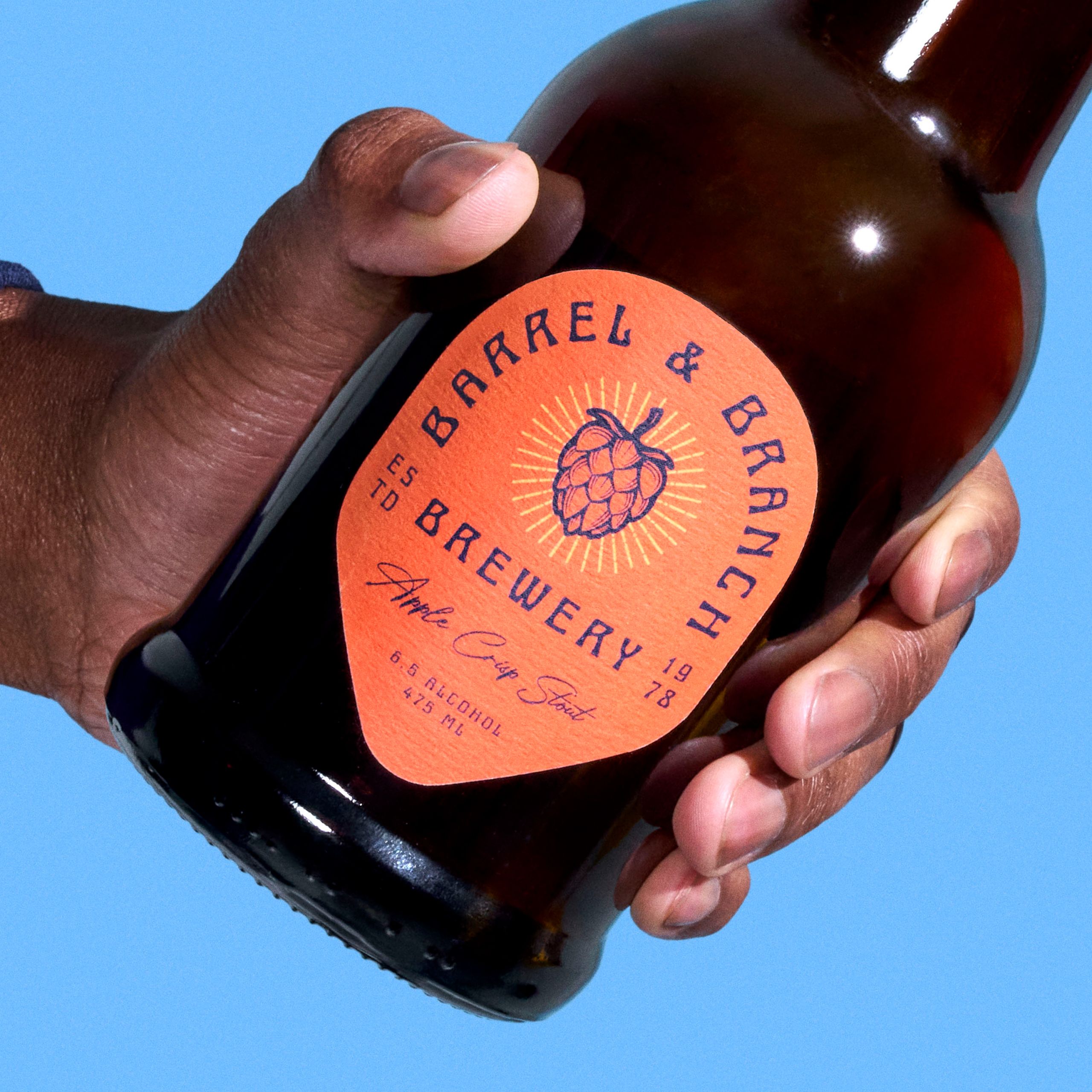 Brown glass bottle with a decorative craft brewery product label.